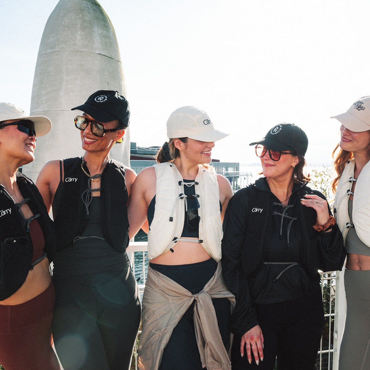Group of women in athletic wear with The Carry hats outdoors.