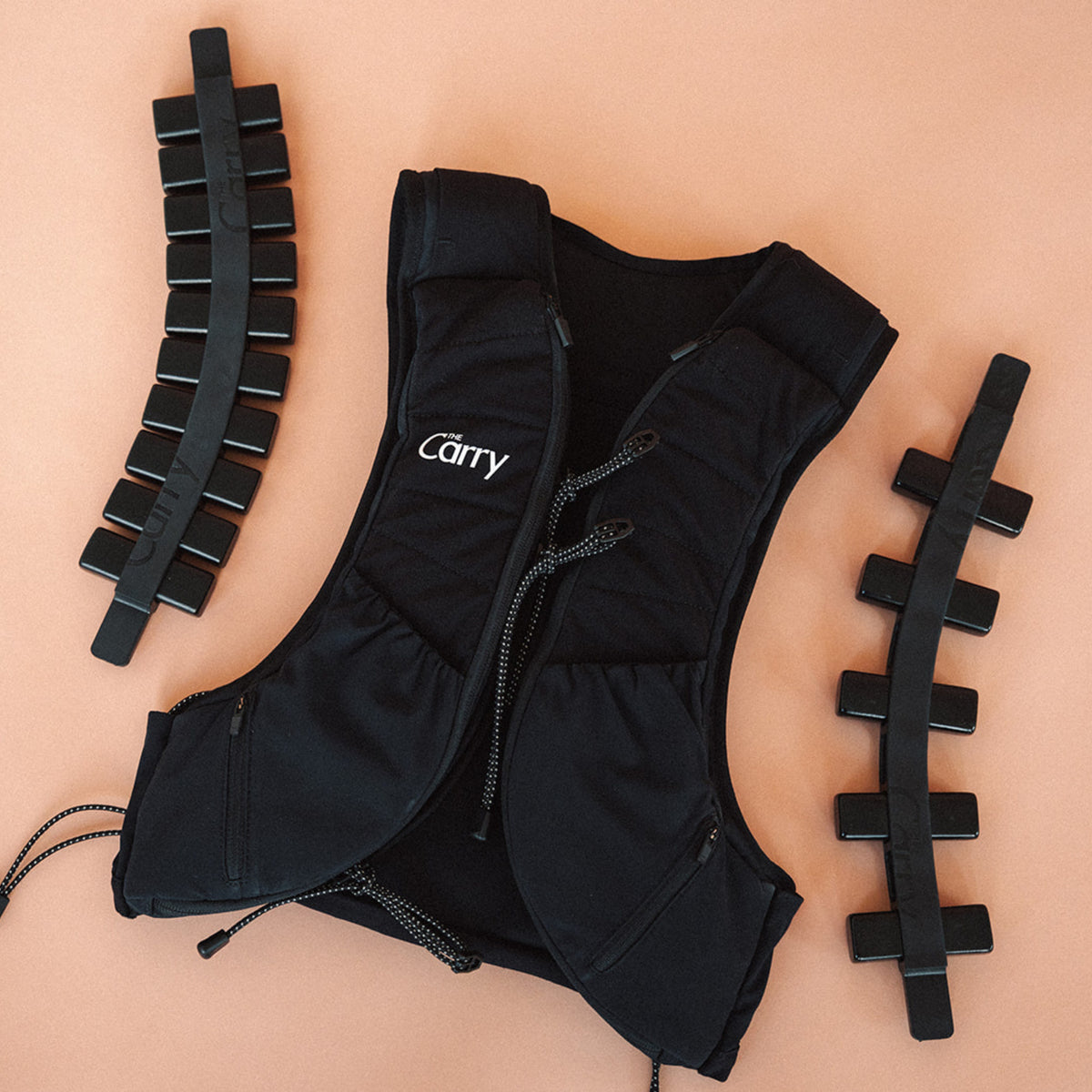 The Carry weighted vest shell in black, showing the adjustable weight system—fully loaded spine and half loaded spine