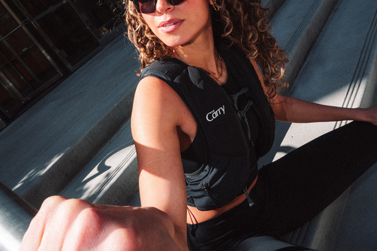 athletic woman in stylish, black weighted vest by The Carry
