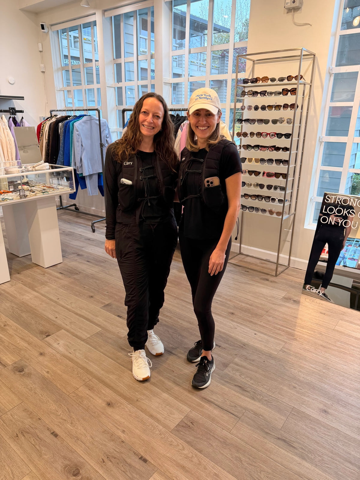 Two women standing in a store with The Carry Weighted Vests on