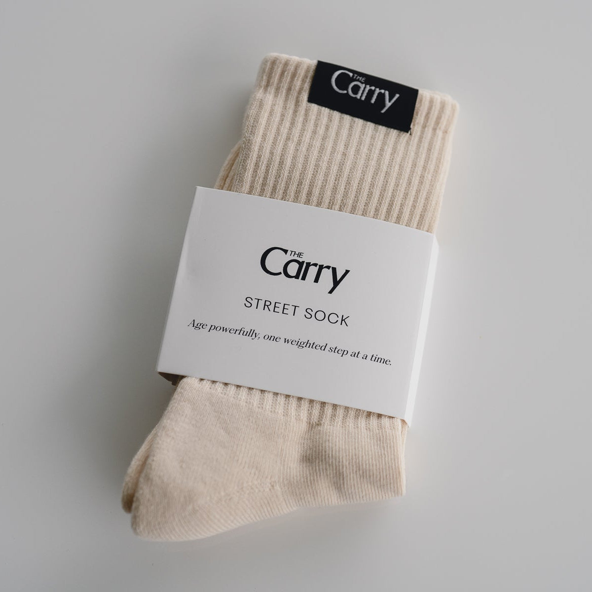 Beige socks with 'The Carry' label on a gray background