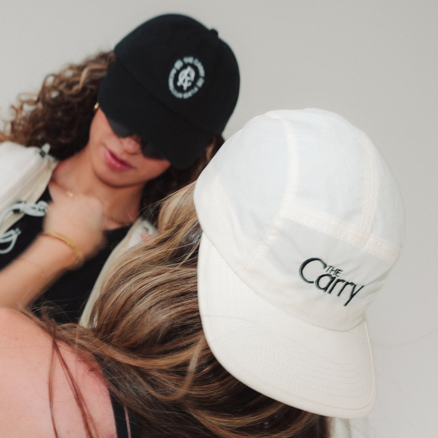 Women wearing The Carry branded hats
