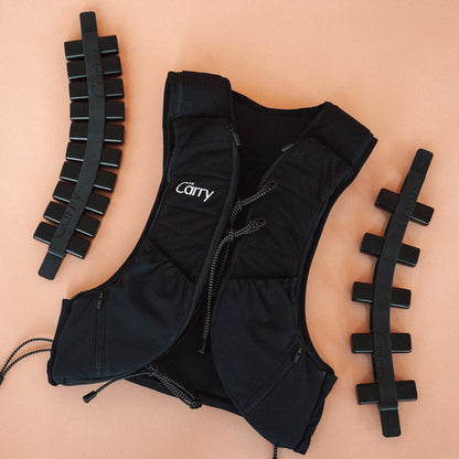 The Carry weighted vest shell in black, showing the adjustable weight system—fully loaded spine and half loaded spine