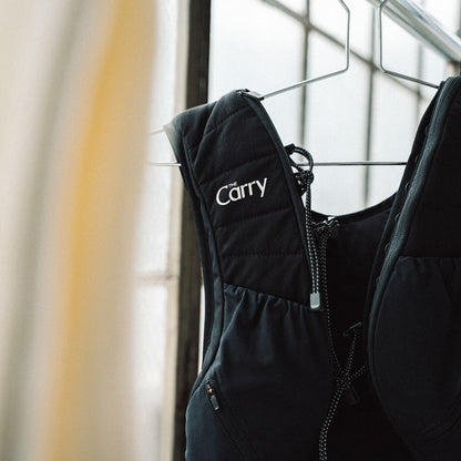 The Carry Vest shell in black on hanger