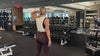 Demonstrating weighted workouts: weighted oblique standing side crunches in The Carry weighted vest
