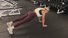 Demonstrating weighted workouts: weighted plank + shoulder taps in The Carry weighted vest